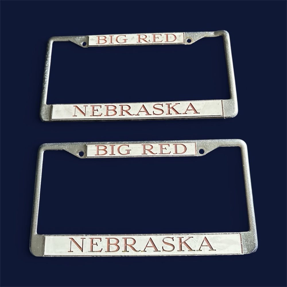 2 vintage Nebraska Big Red metal license plate holders